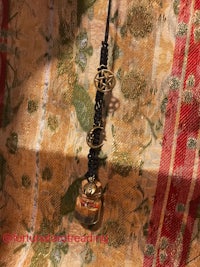 a wand with a tarot card attached to it