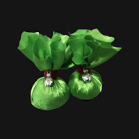 two green bags with red bows on a black background